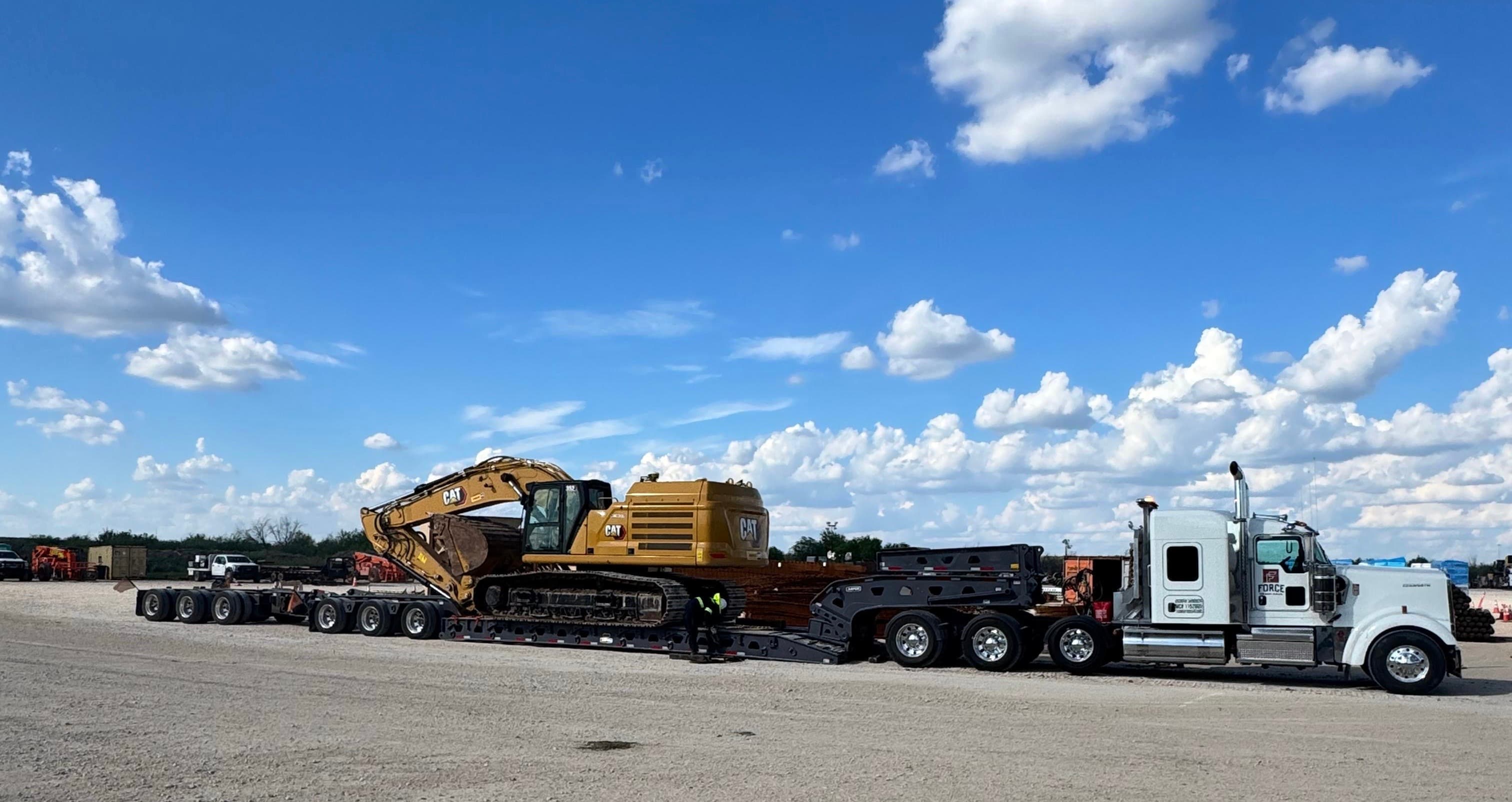 Heavy equipment hauling Laredo TX — excavator on trailer